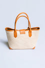 The Winding Road Rolled Leather Handle Rattan Tote